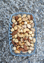 mix of various salted nuts on a glass bowl