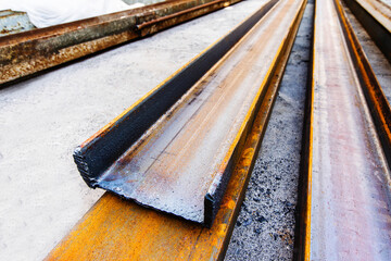 Corroded metal beams are located at the construction site. Foreground. selective focus