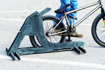 Wooden bike rack. Simple design for storage of two-wheeled vehicles. Close-up