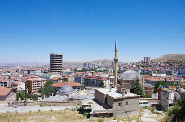 In the foreground a mosque and in the background the city of Nevsehir -  Turkey