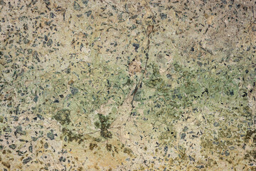 Old cracked concrete with copper oxide.