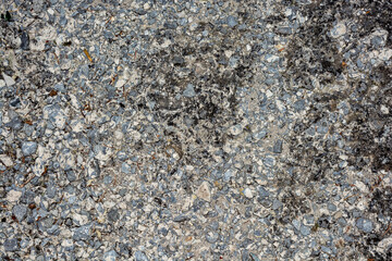 Old destroyed concrete, with broken gravel and cracks.