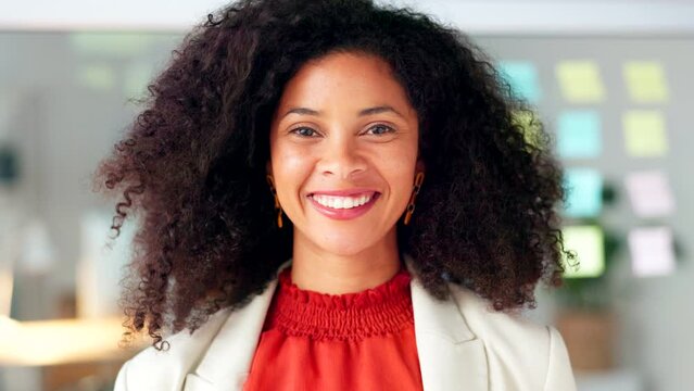 Portrait of a black business woman smiling and laughing while working in an office. One confident manager and cheerful african entrepreneur with curly hair feeling motivated and ambitious for success