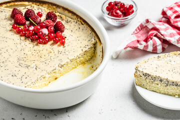 Healthy baked cottage cheese casserole, poppy seeds, frozen berries. Top view, copy space.