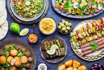 Arabic cuisine; Middle Eastern traditional dishes. Stuffed vine leaves, olives, hummus, pita bread, falafel, sambusak, kibbeh, shish tawook, meat kebab, tabbouleh and fattoush salad. 