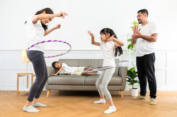 Young  asian parents with child meditating at home isolated in room.  Family, sport, yoga concept.