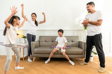 Naklejka premium Young asian parents with child meditating at home isolated in room. Family, sport, yoga concept.