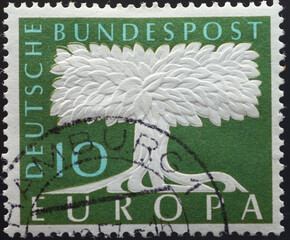 GERMANY - CIRCA 1957: a postage stamp from GERMANY, showing a stylized tree as an embossed print....