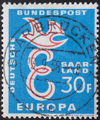 Germany - circa 1958: a postage stamp from Germany , showing a capital E and a dove on it as a...
