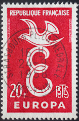 France - circa 1958: a postage stamp from France , showing a capital E and a dove on it as a community issue from European states. Text: Europe