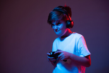 The boy emotionally plays the joystick © stenkovlad