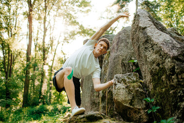 Naklejka na ściany i meble Man doing sport exercises in the forest