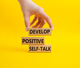 Develop positive self-talk symbol. Concept words Develop positive self-talk on wooden blocks....