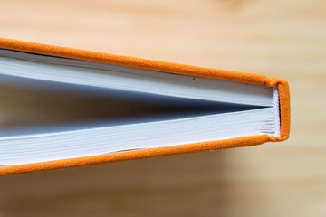 book with orange cloth cover
