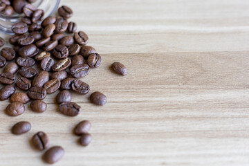 top view of coffee beans on wooden table with glass bottle