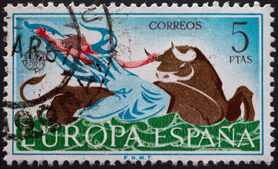 Spain - circa 1966: a postage stamp from Spain, showing a man taking a bull by the horns. CEPT emblem . Text: Europe