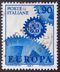 ITALY - CIRCA 1967: a postage stamp from ITALY , showing a gears meshing with the emblem of the CEPT. Text : EUROPE. Circa 1967