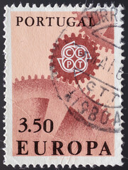 PORTUGAL - CIRCA 1967: a postage stamp from PORTUGAL , showing a gears meshing with the emblem of the CEPT. Text : EUROPE. Circa 1967
