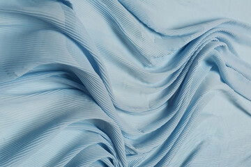 Blue chiffon fabric crumpled or wavy fabric texture background. Abstract linen cloth soft waves. Silk yarn. Smooth elegant luxury cloth texture. Concept for banner or advertisement.