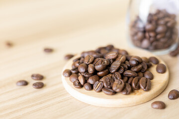 close up of coffee beans roasted on wooden table 