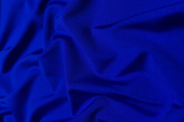 Blue supplex crumpled or wavy fabric texture background. Abstract linen cloth soft waves. Silk fabric. Smooth elegant luxury cloth texture. Concept for banner or advertisement.