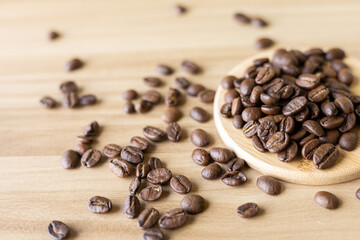 close up of coffee beans roasted on wooden table 