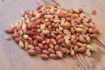 salted peanuts on wooden table.
