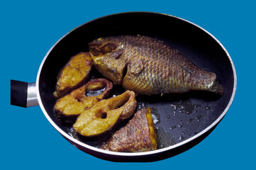Tilapia frying in fry-pen with oil. Top  view.