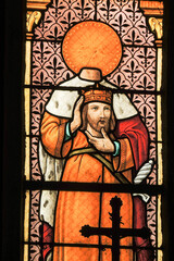 Ploumilliau (Plouilio), France. Stained glass window depicting Saint Milliau of Cornwall holding his beheaded or decapitated head inside the church