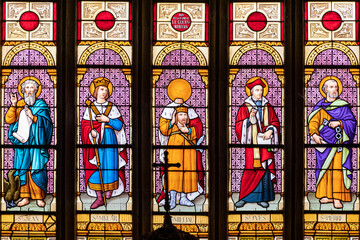 Ploumilliau (Plouilio), France. Stained glass window in St Miliau Church depicting saints John, Melor, Milliau, Ivo and Peter