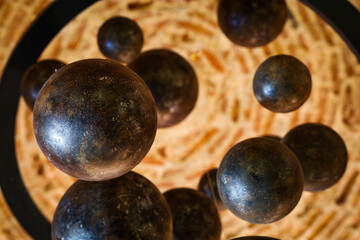black balls in a circle with bokeh