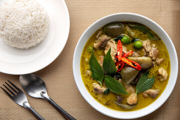 Thai food chicken green curry on table background. top view.