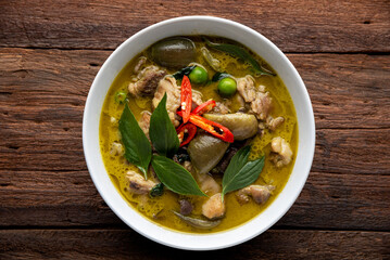 Thai food chicken green curry on table background. top view.