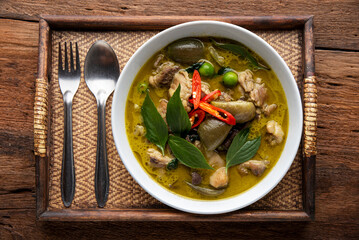 Thai food chicken green curry on table background. top view.