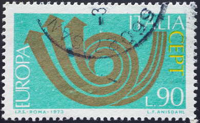 ITALY - CIRCA 1973: a postage stamp from ITALY , showing a stylized post horn. Text: Europe, CEPT. Circa 1973