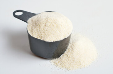 Guar gum, also called guaran, is a galactomannan polysaccharide extracted from guar beans. On white background.