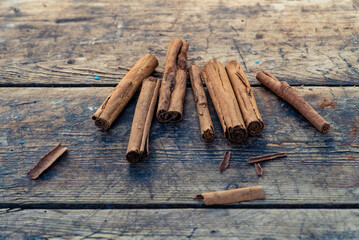 Organic Raw Brown  cinnamon sticks on old wooden table  wood stump trunk outdoor