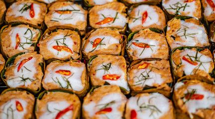 Steamed fish in banana leaf containers made for sale in the traditional Chinese market of Ban Chak Ngaew, Thailand.