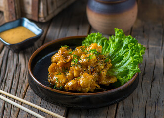 GOMA SHRIMP POPCORN with sauce served in a dish isolated on wooden background side view of appetizer
