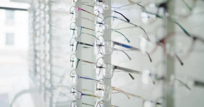 Fashionable corrective eye glasses on a shelf of an optical shop for clients to choose from. Spectacles or prescription lenses with frames at an optometry clinic. A rack full of stylish eyewear