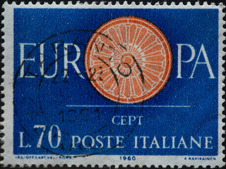 ITALY - CIRCA 1960: a postage stamp from ITALY , showing a wagon wheel as a symbol of solidarity...