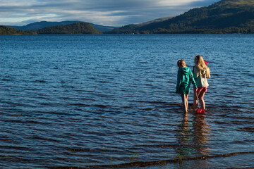 Fototapeta premium Children having fun playing on Loch Lomond Beech 
