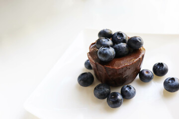 summer desserts. chocolate dessert with blueberries on a white plate