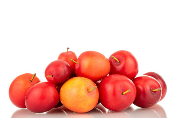Several ripe juicy cherry plums, close-up, isolated on a white background.