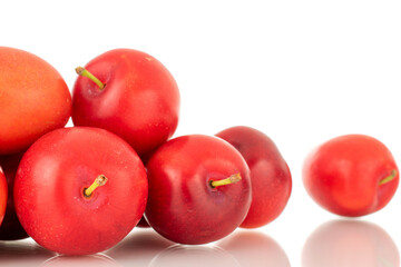 Several ripe juicy cherry plums, close-up, isolated on a white background.