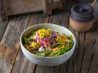 KANI SALAD served in a dish isolated on wooden background side view of salad