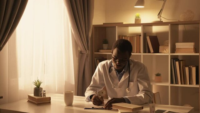 Doctor lifestyle. Medic career. Professional occupation. Confident busy male physician working writing prescription at modern interior with free space.