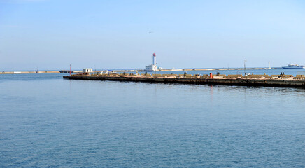 Fototapeta na wymiar Marine pier, breakwater and lighthouse at sea harbour, Odesa sea