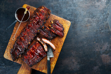 Barbecue pork spare loin ribs St Louis cut with hot honey chili marinade served as top view on a...