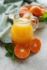 Fototapeta na wymiar Jug of fresh orange tangerine juice